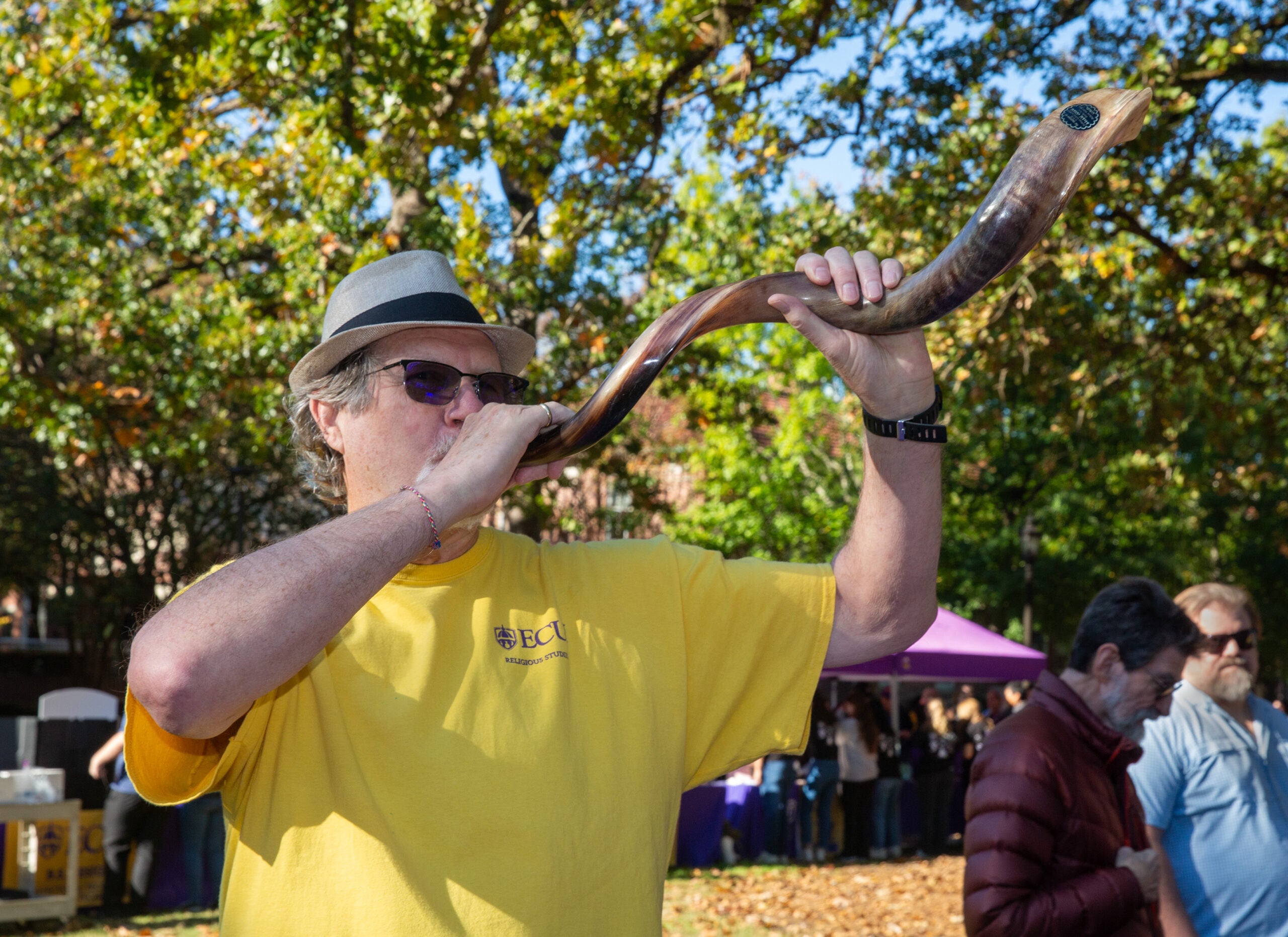 Man playing a ceremonial wind instrument